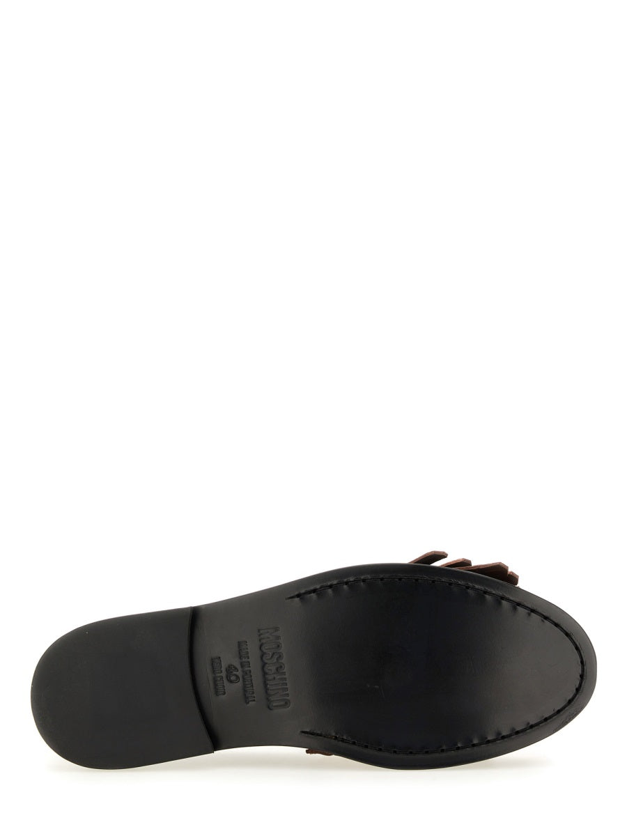 MOCCASIN WITH BANGS AND COIN